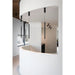 Modern interior with black cylinder pendant lights, ceiling mounted, and black track lighting.
