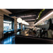 Modern coffee shop interior with black speckled countertops and globe pendant lights.