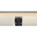 Recessed black aluminum track lighting rail, mounted to ceiling.