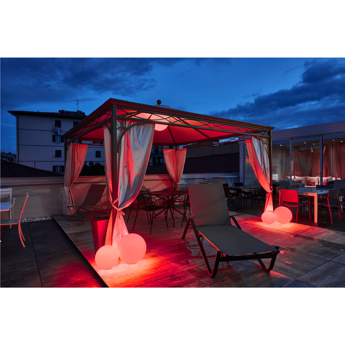 Outdoor patio with metal gazebo, white curtains, lounge chair, dining set, and red glowing sphere lights.
